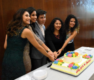 Leadership of Mi Familia cutting cake