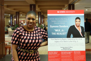 Symone Sanders poses for photo with her poster on Thursday, Jan. 17 at McKimmon Center. Her 2019 Dr. Martin Luther King, Jr. Campus Commemoration Keynote Address was titled "MLK, Jr.: THE REALIST."